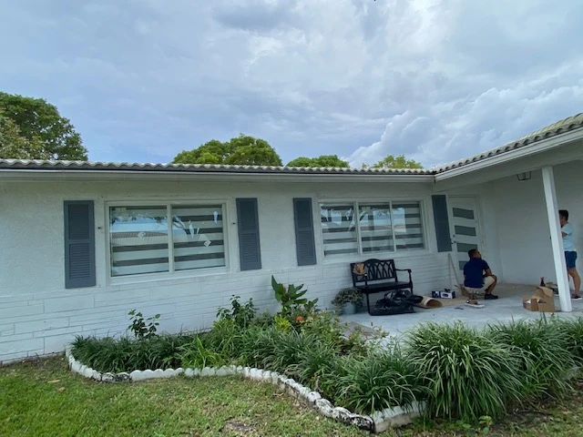 Empower Solution FK technicians installing impact windows on a Florida home
